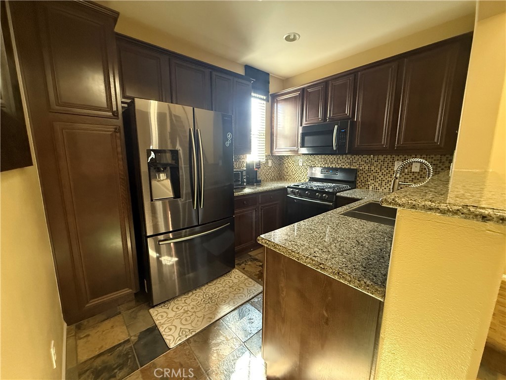 44965 Blue Rosemary Way Temecula, CA 92592 - Photo 15 of 25 a kitchen with a refrigerator sink and microwave