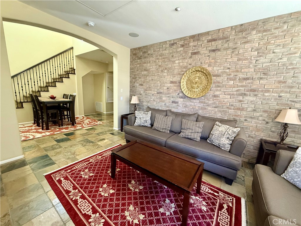 44965 Blue Rosemary Way Temecula, CA 92592 - Photo 3 of 25 a living room with furniture and a fireplace