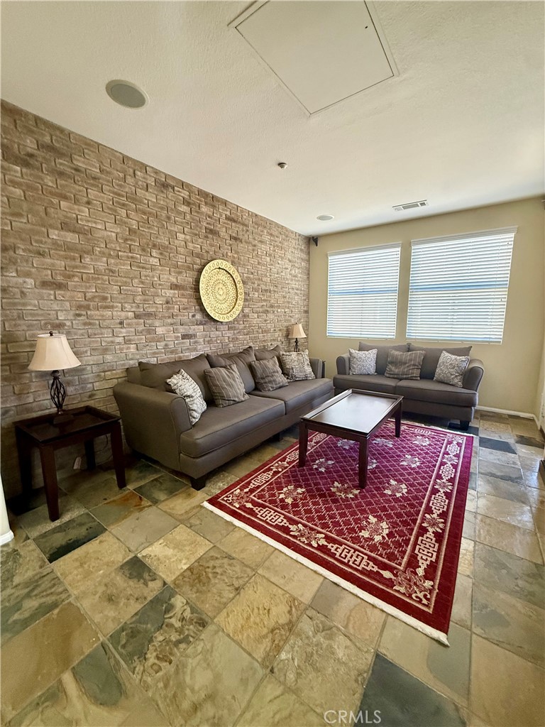 44965 Blue Rosemary Way Temecula, CA 92592 - Photo 5 of 25 a living room with furniture and a rug