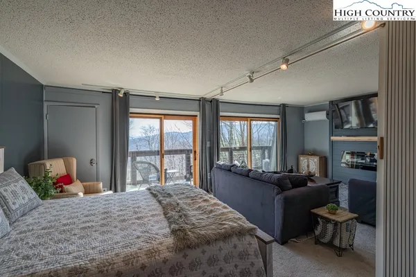 a bedroom with a bed and a couch