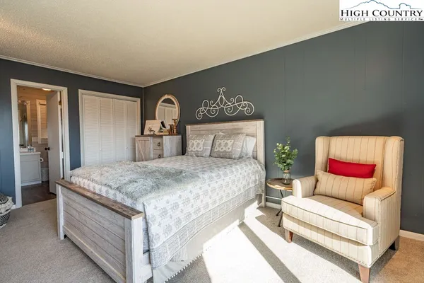 a bedroom with a bed and a dresser