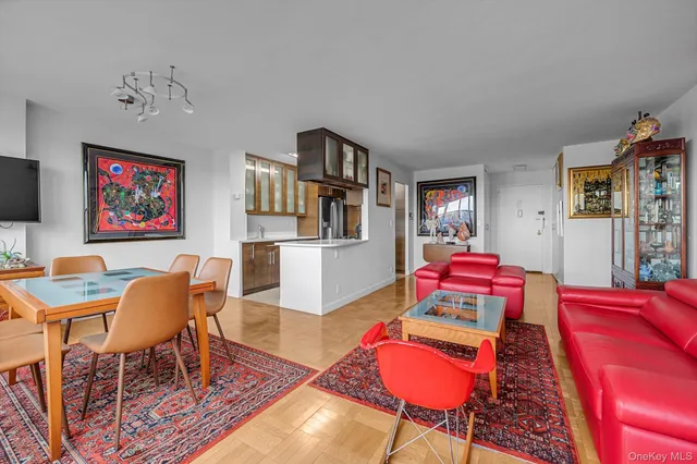 a living room with furniture a rug and a wall painting