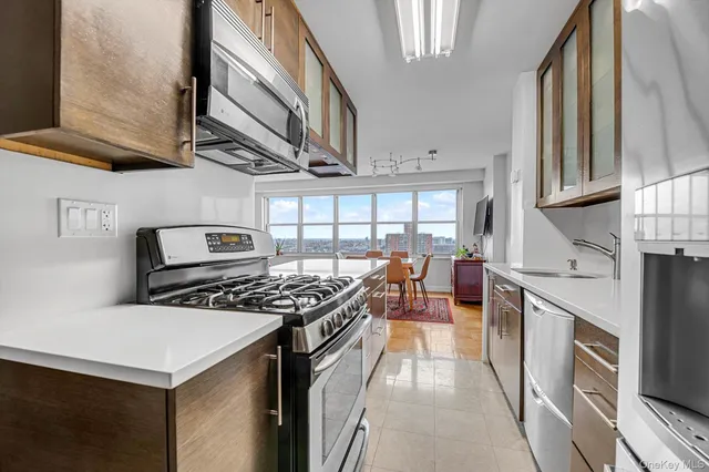 a kitchen with stainless steel appliances a stove a sink dishwasher and cabinets