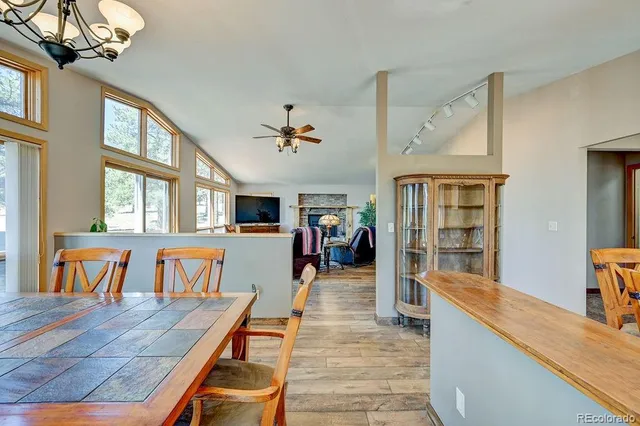 a living room with furniture a dining table and chairs with wooden floor