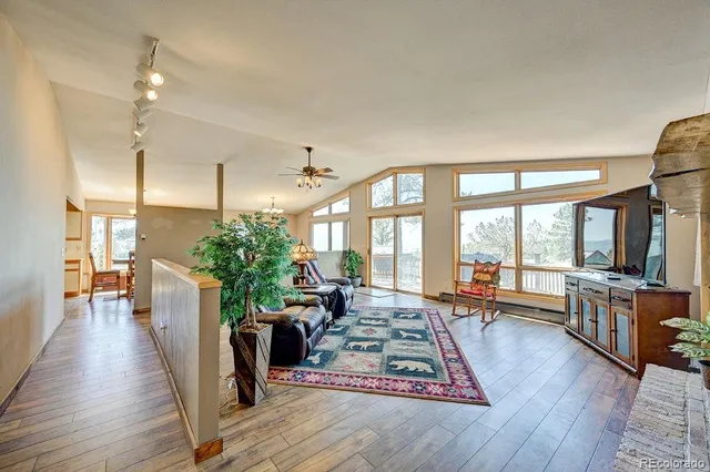 a living room with furniture windows and wooden floor