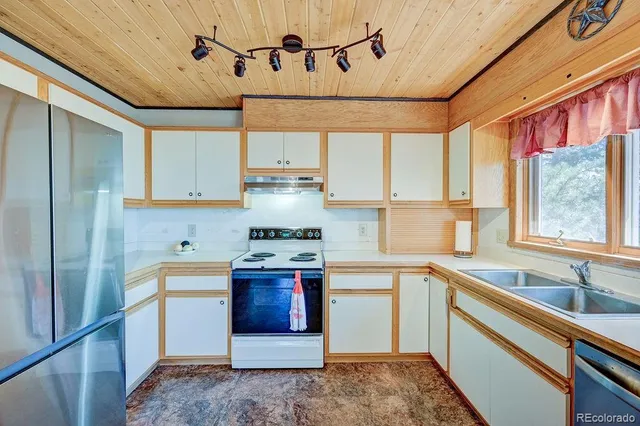 a bedroom with a bed and a flat tv screen on dresser