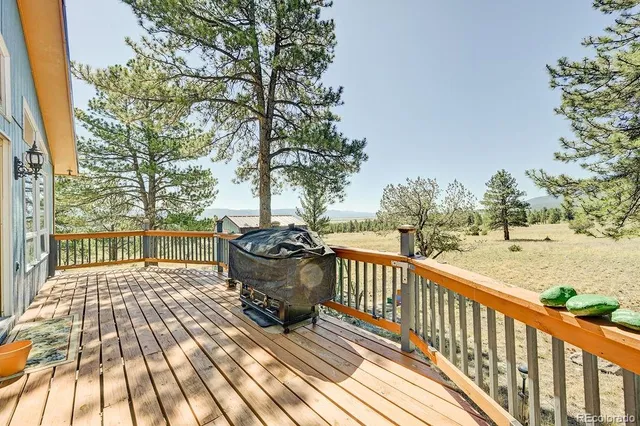 a view of balcony with wooden floor and outdoor seating