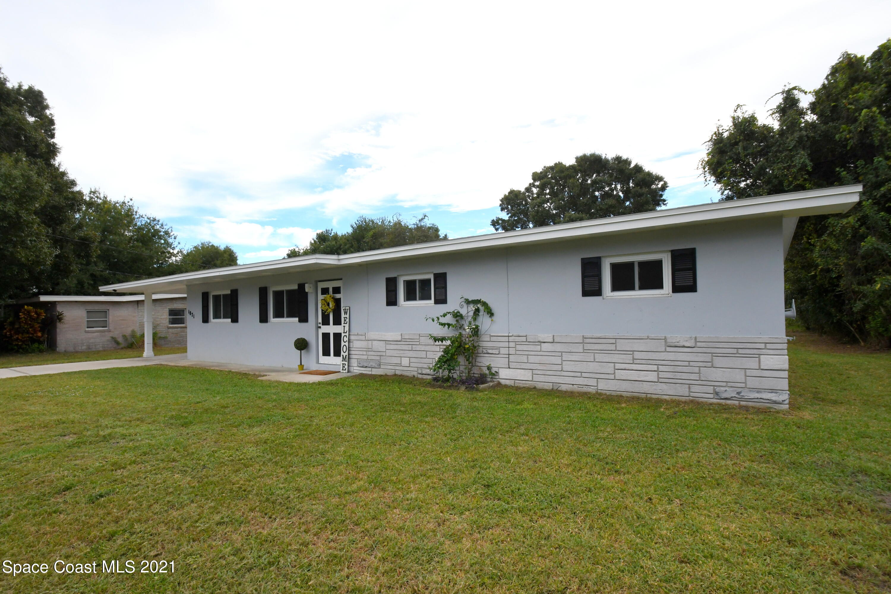 1871 Pinewood Road Melbourne, FL 32934 - Photo 2 of 22 a front view of house with yard and green space