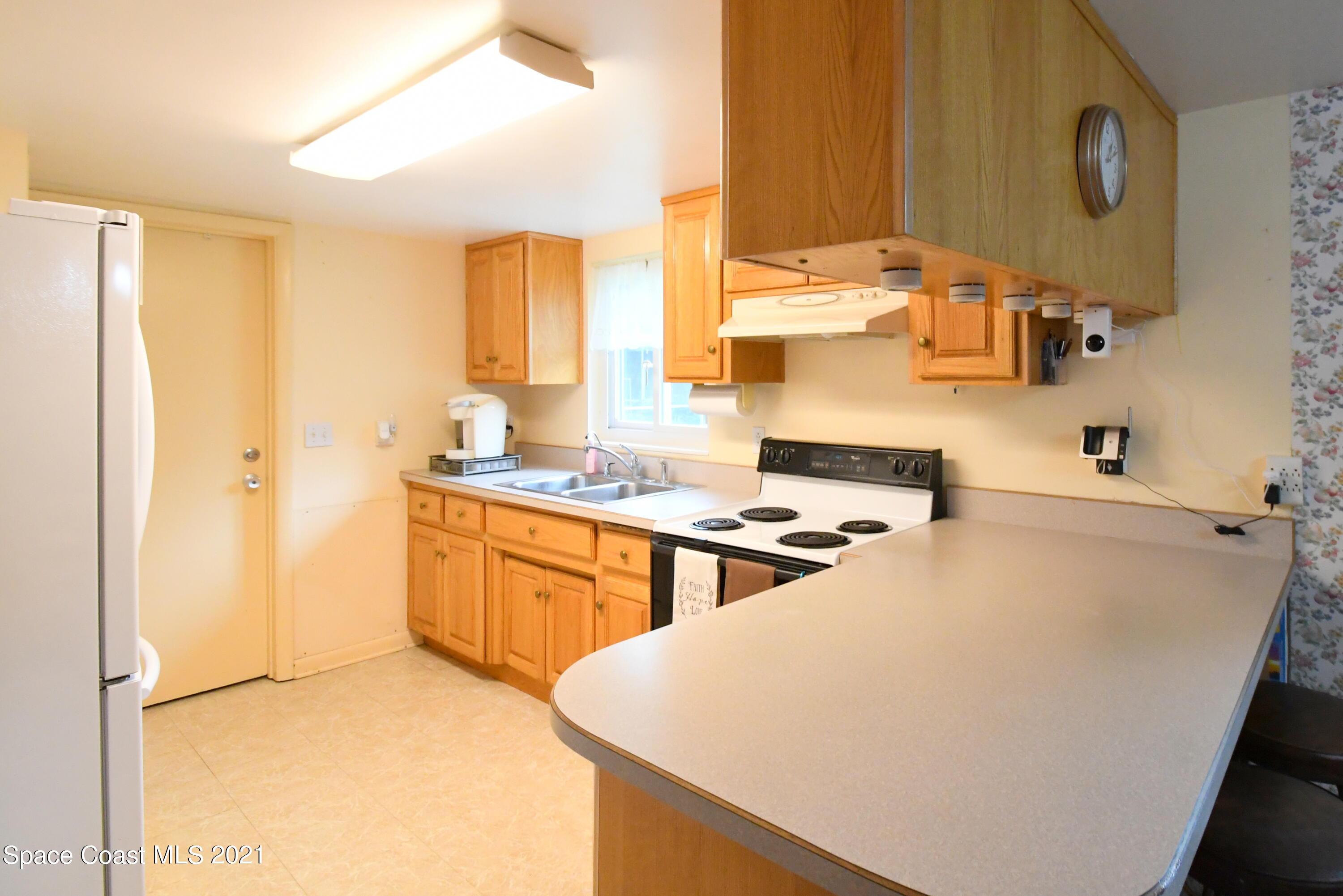 1871 Pinewood Road Melbourne, FL 32934 - Photo 13 of 22 a kitchen with stainless steel appliances a stove a sink and a refrigerator