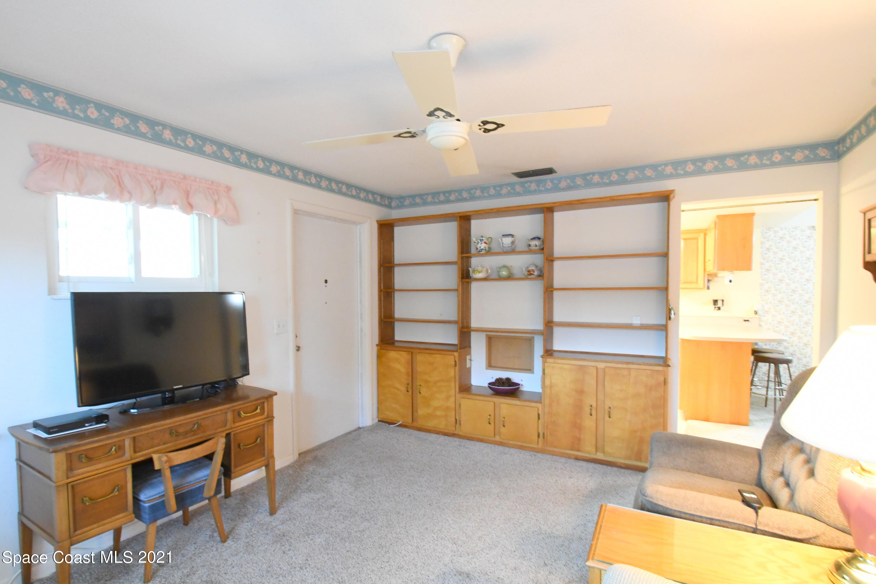1871 Pinewood Road Melbourne, FL 32934 - Photo 15 of 22 a living room with furniture and a flat screen tv