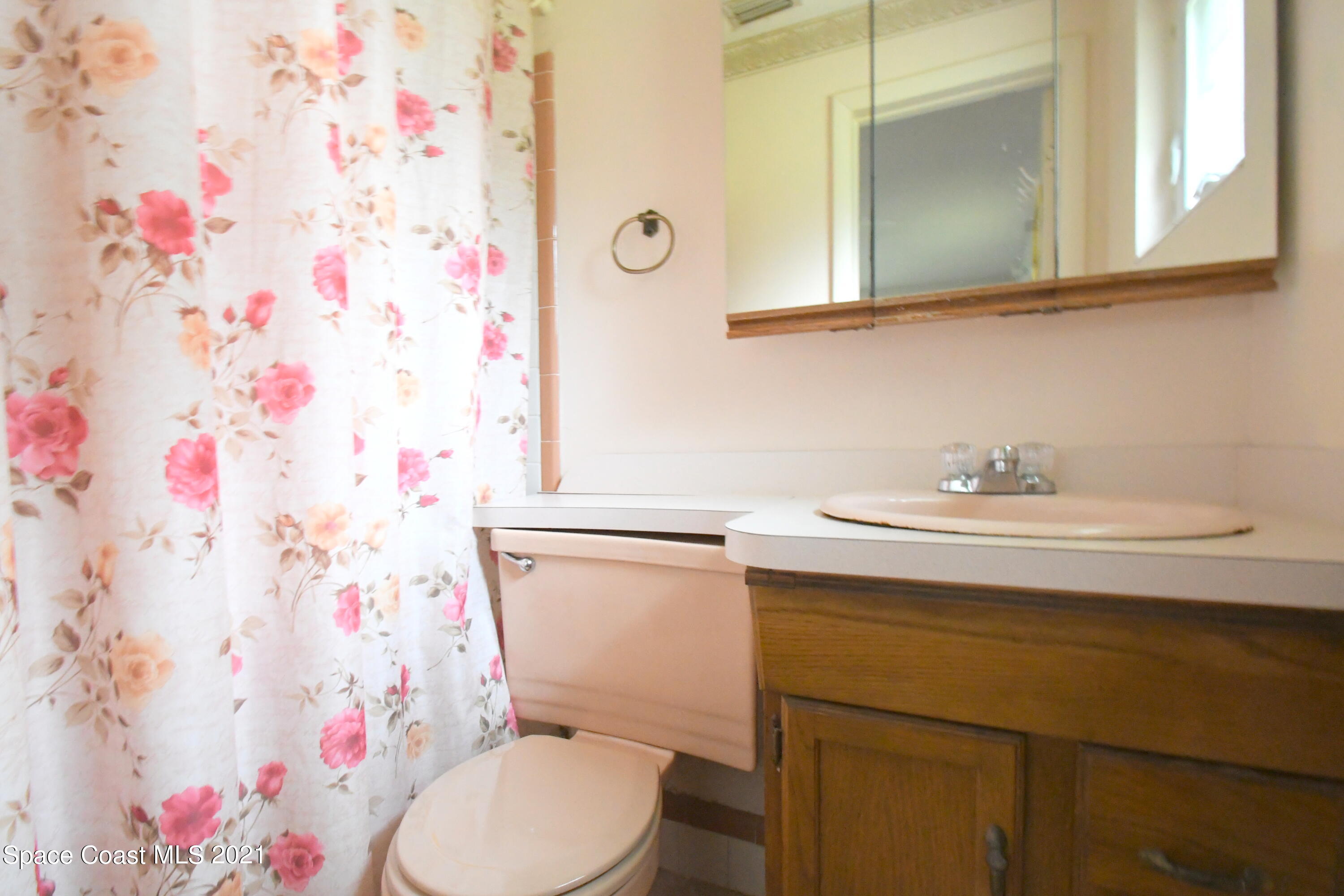 1871 Pinewood Road Melbourne, FL 32934 - Photo 18 of 22 a bathroom with a sink toilet and mirror