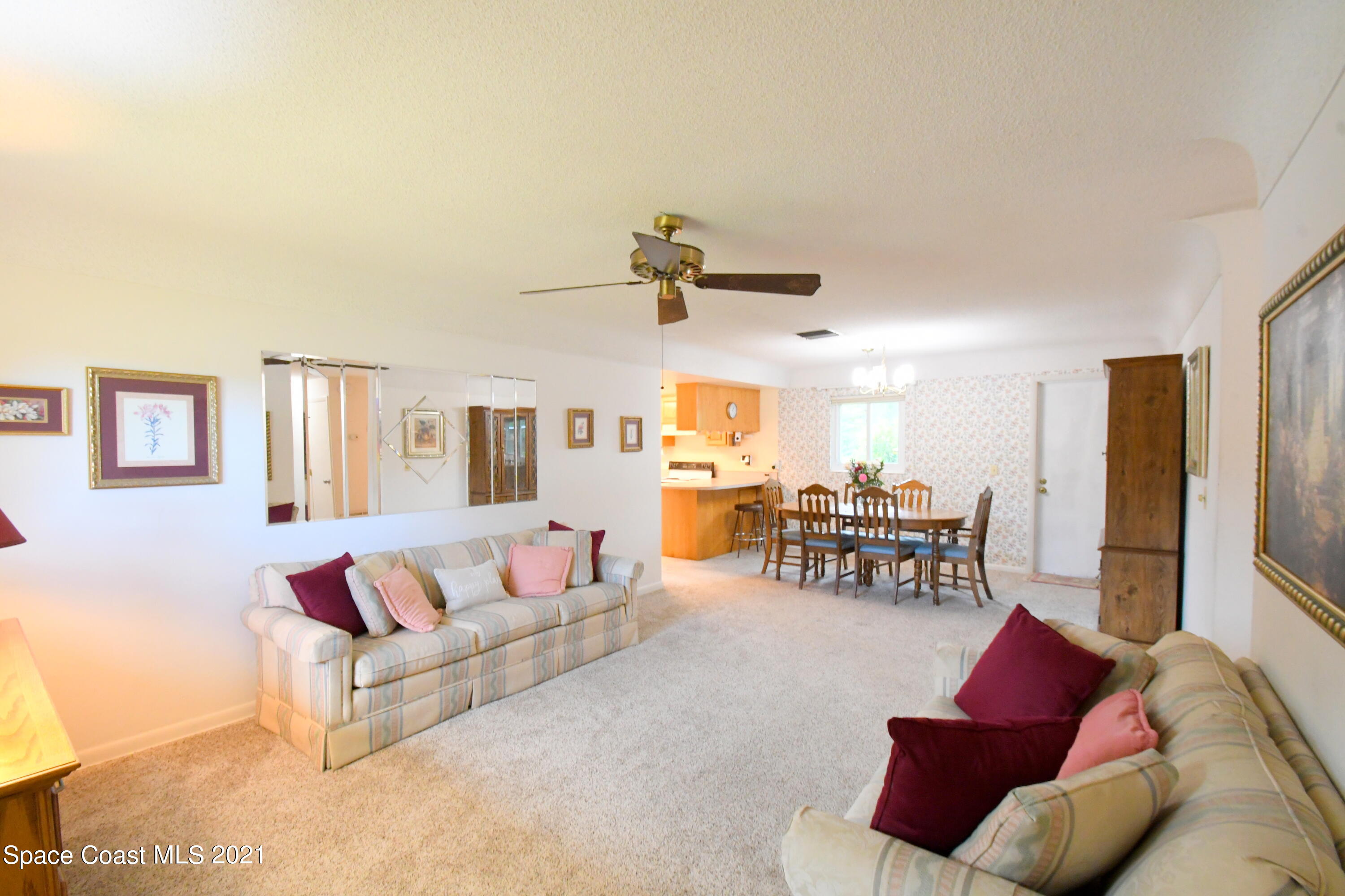 1871 Pinewood Road Melbourne, FL 32934 - Photo 5 of 22 a living room with furniture and a chandelier