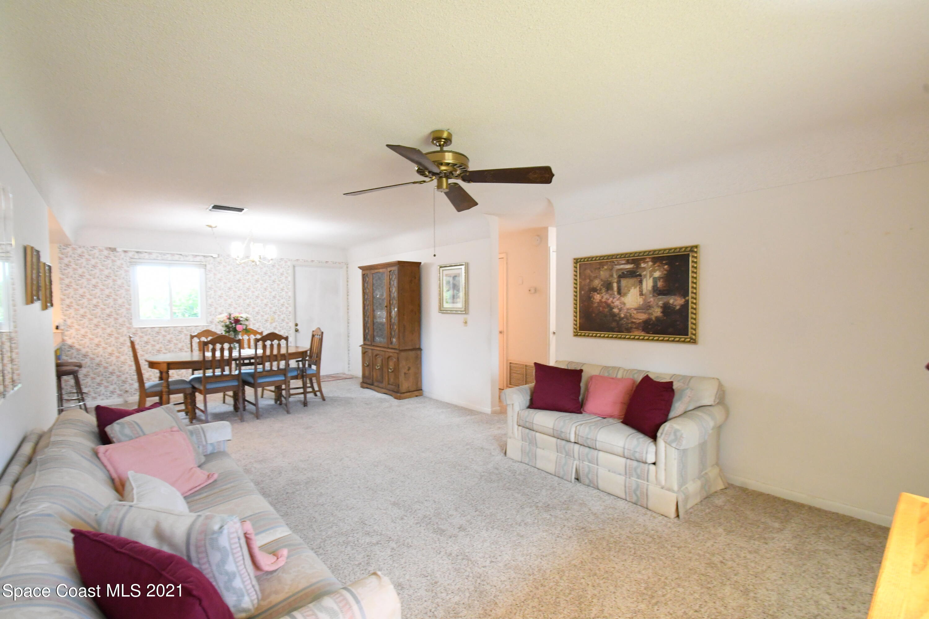 1871 Pinewood Road Melbourne, FL 32934 - Photo 6 of 22 a living room with furniture and a ceiling fan