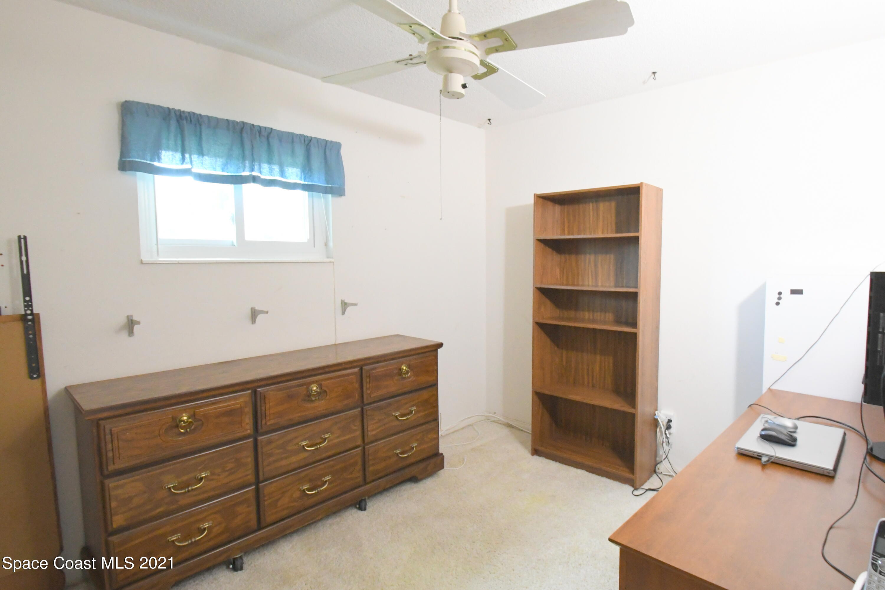 1871 Pinewood Road Melbourne, FL 32934 - Photo 8 of 22 a view of room with cabinet and windows