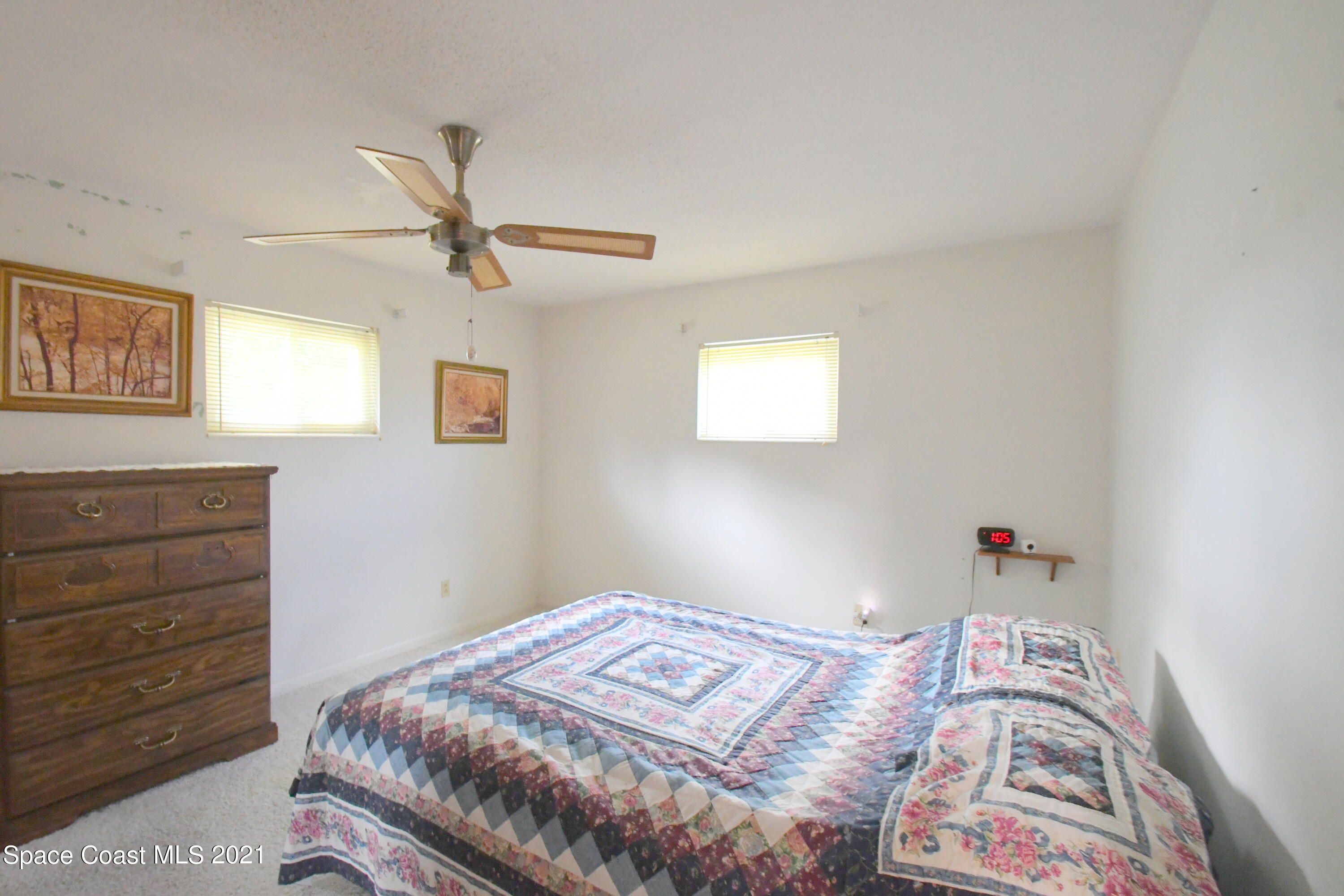 1871 Pinewood Road Melbourne, FL 32934 - Photo 9 of 22 a bedroom with a bed and a dresser