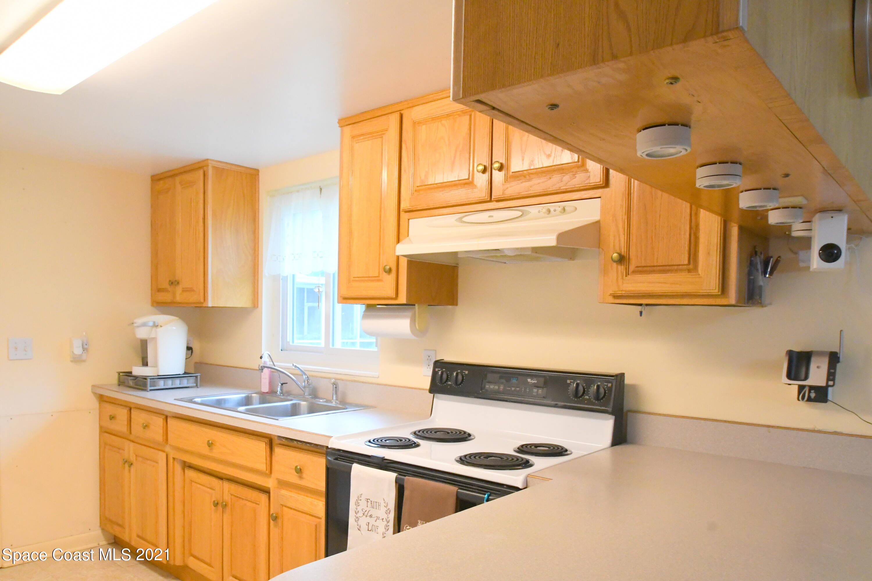 1871 Pinewood Road Melbourne, FL 32934 - Photo 10 of 22 a kitchen with stainless steel appliances kitchen island granite countertop a sink and cabinets