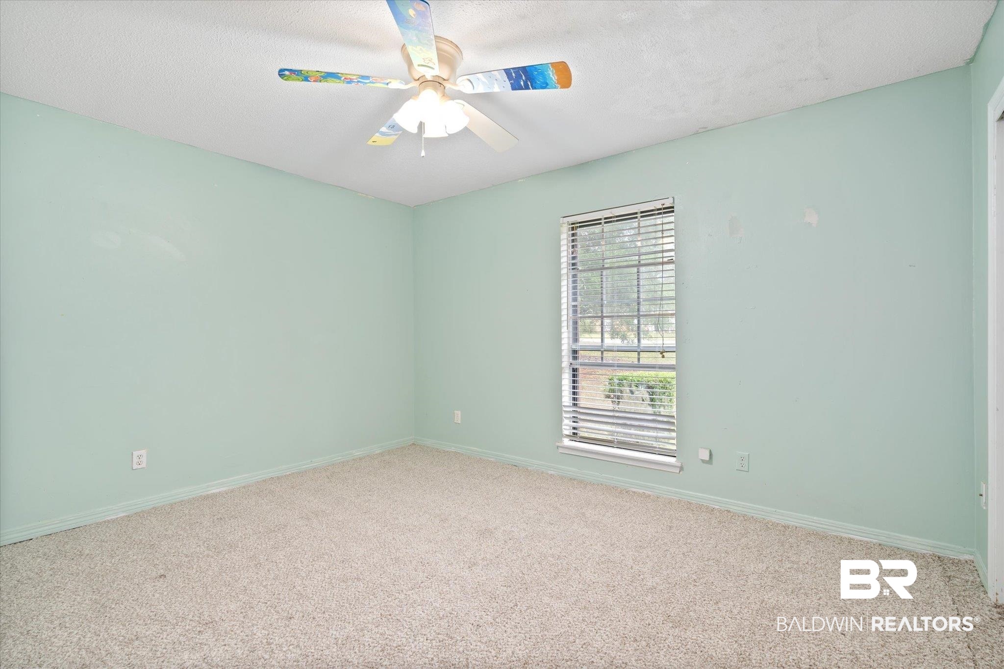 9445 Howells Ferry Road Semmes, AL 36575 - Photo 14 of 20 Empty room with a textured ceiling, carpet floors, and ceiling fan