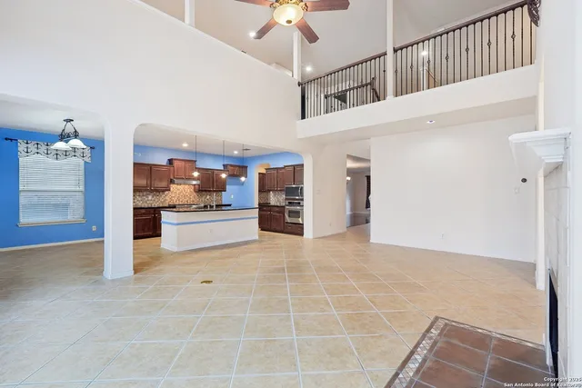 a kitchen that has a lot of cabinets and a wooden floor