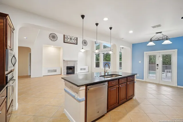 a kitchen with stainless steel appliances a sink stove and refrigerator