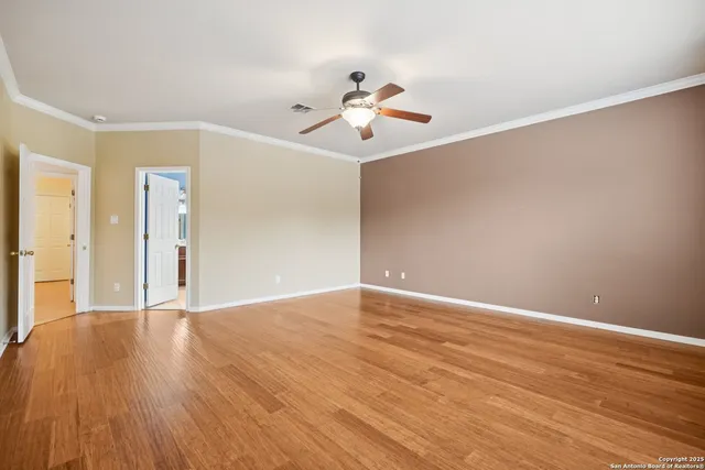 a view of empty room with wooden floor