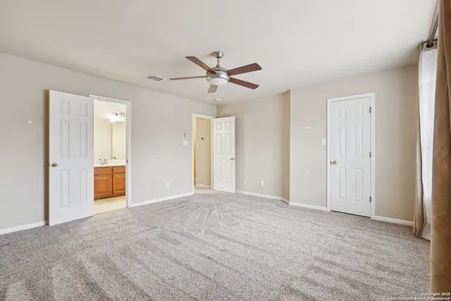 a bathroom with a toilet and shower curtain