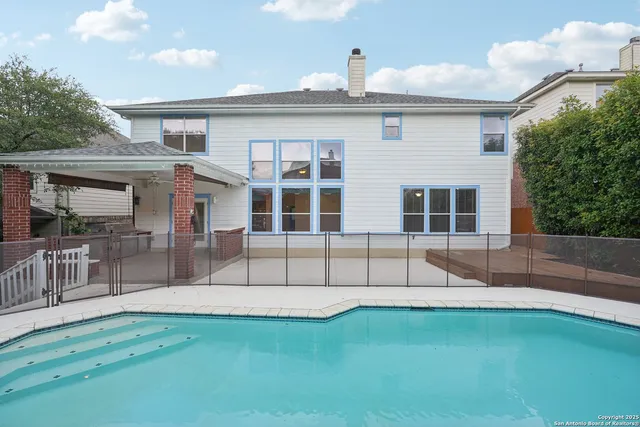 a view of a swimming pool with a yard