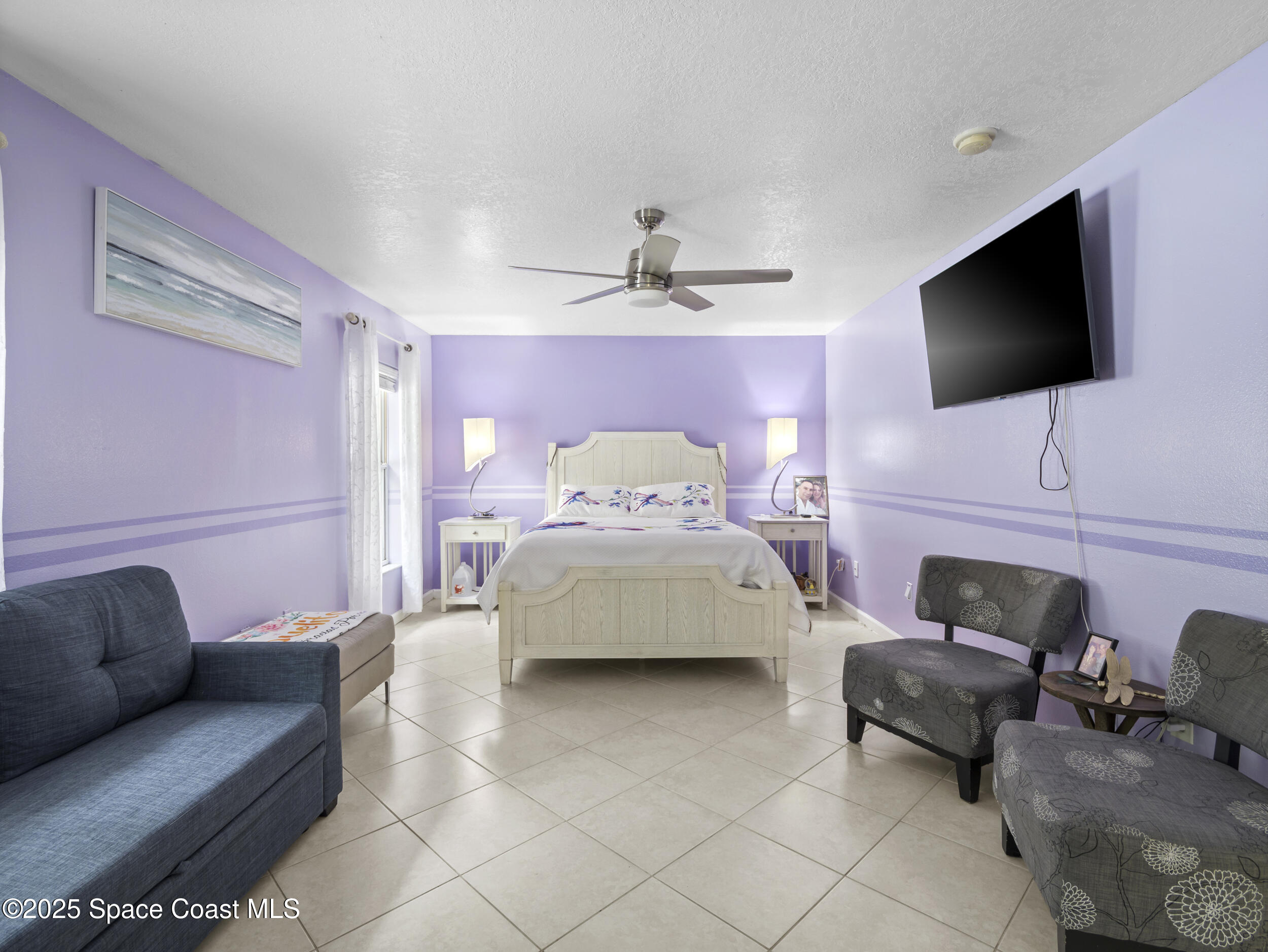 860 Tupelo Road Southwest Palm Bay, FL 32908 - Photo 11 of 26 a living room with furniture and a flat screen tv