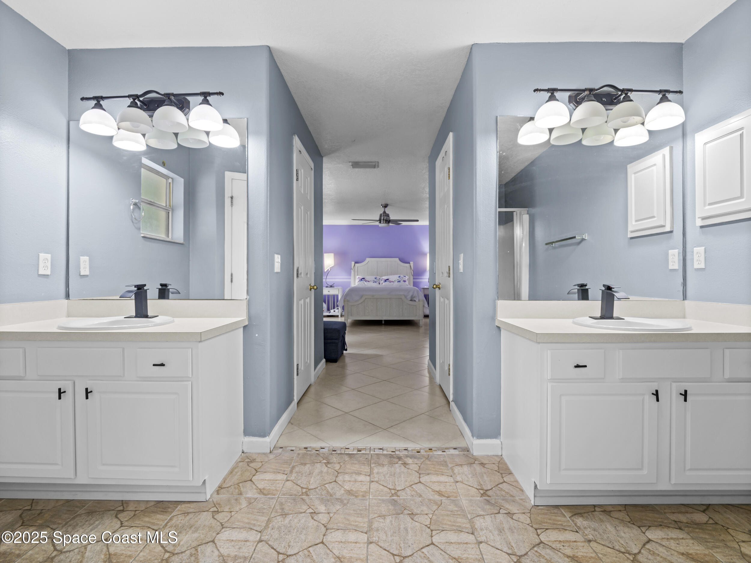 860 Tupelo Road Southwest Palm Bay, FL 32908 - Photo 13 of 26 a en suite spacious bathroom with a double vanity sink mirror and