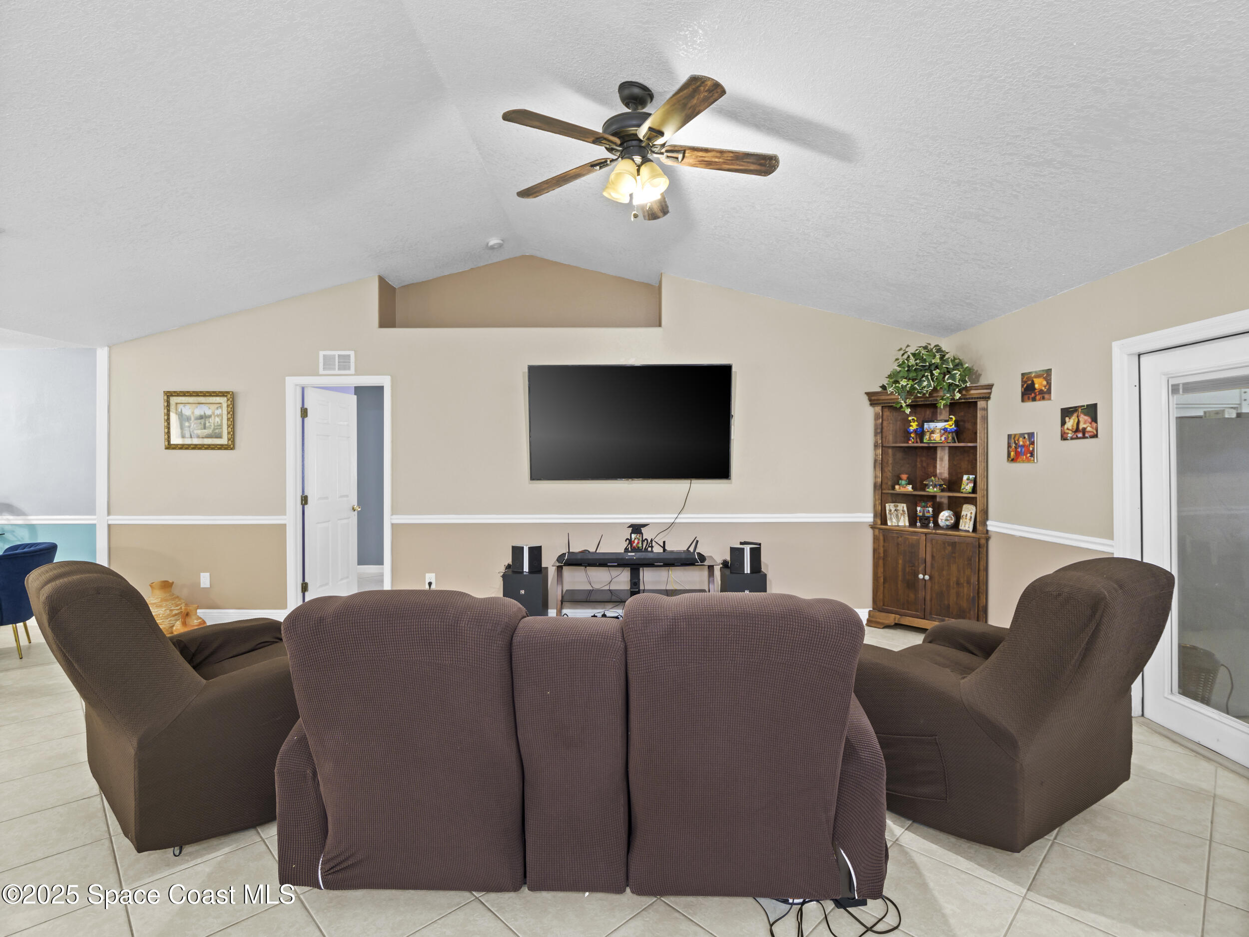 860 Tupelo Road Southwest Palm Bay, FL 32908 - Photo 14 of 26 a living room with furniture and a flat screen tv