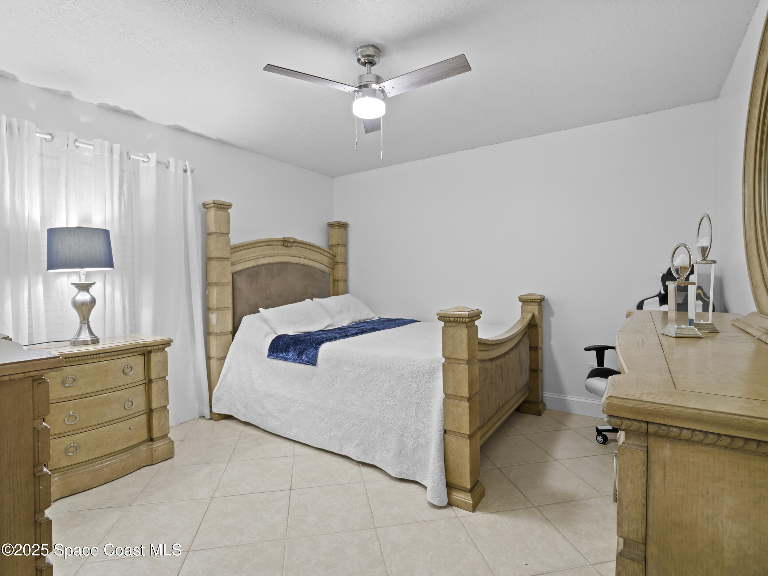 860 Tupelo Road Southwest Palm Bay, FL 32908 - Photo 17 of 26 a bedroom with a bed and cabinets