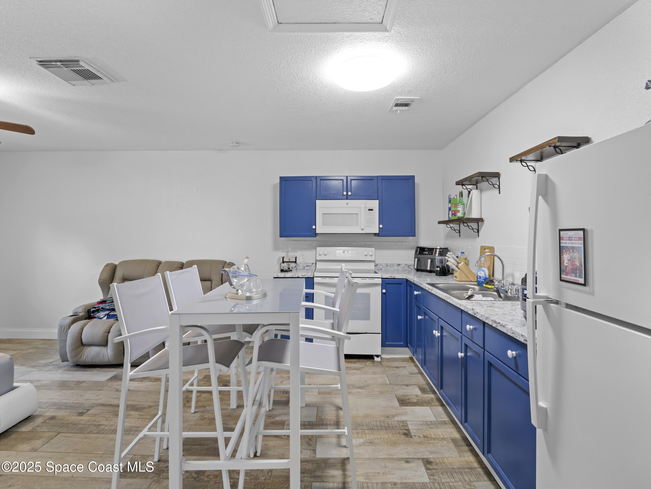 860 Tupelo Road Southwest Palm Bay, FL 32908 - Photo 22 of 26 a large kitchen with cabinets