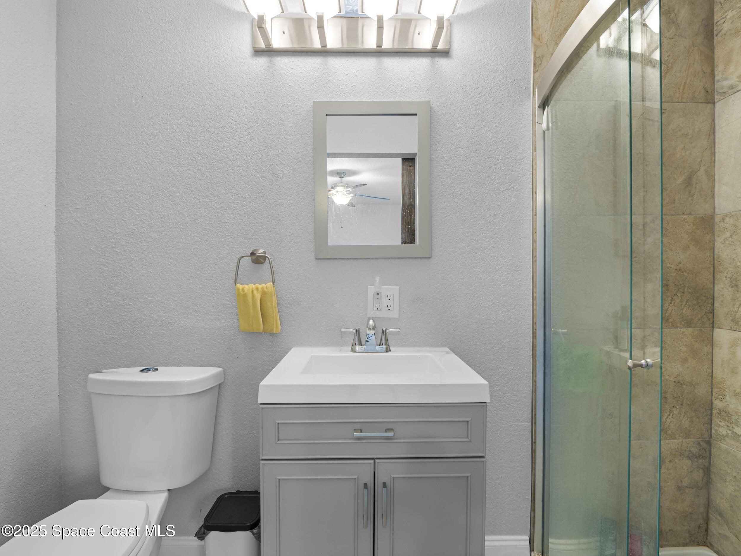 860 Tupelo Road Southwest Palm Bay, FL 32908 - Photo 24 of 26 a bathroom with a toilet sink and mirror