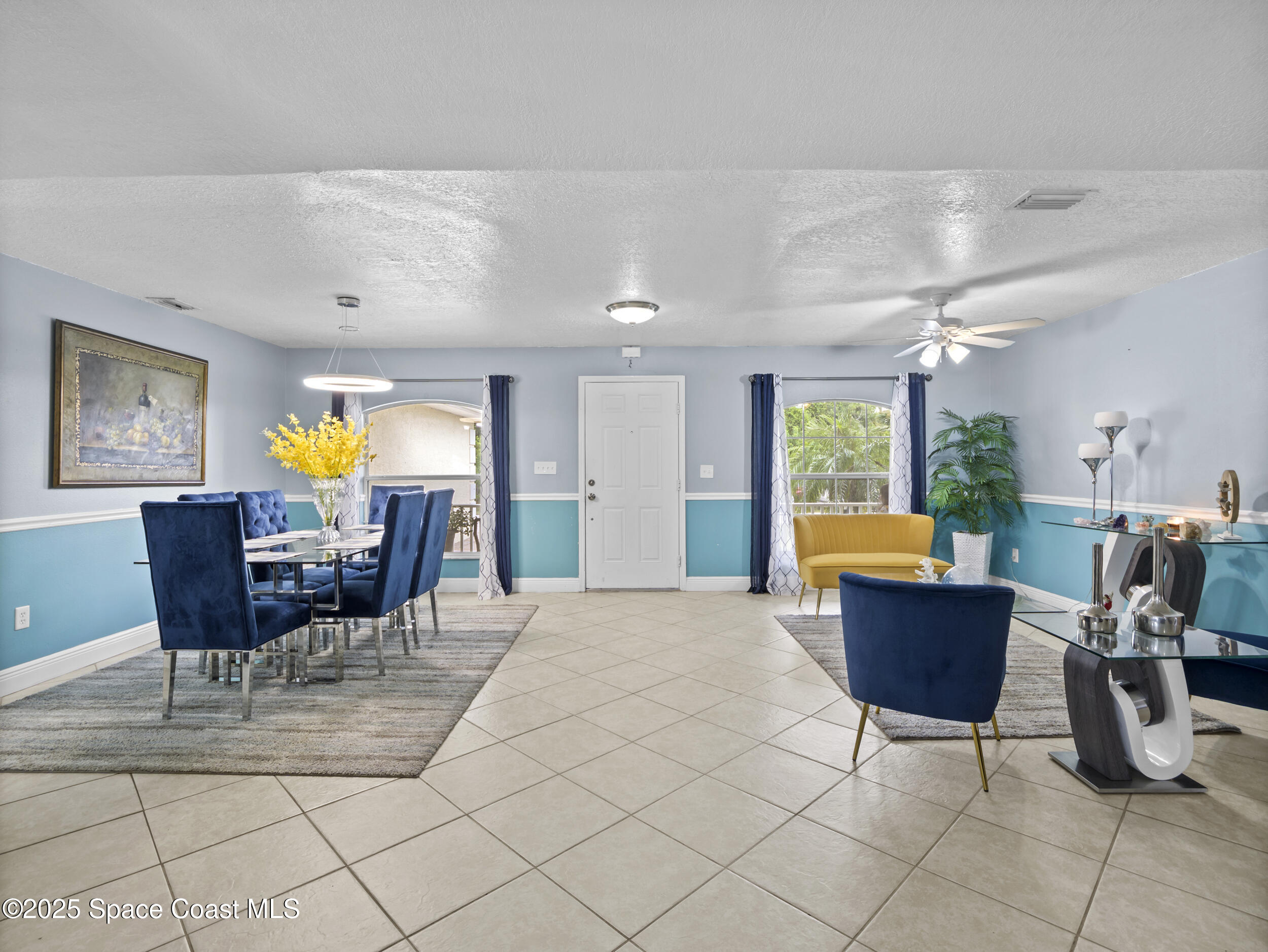 860 Tupelo Road Southwest Palm Bay, FL 32908 - Photo 4 of 26 a view of a dining room with furniture and a chandelier