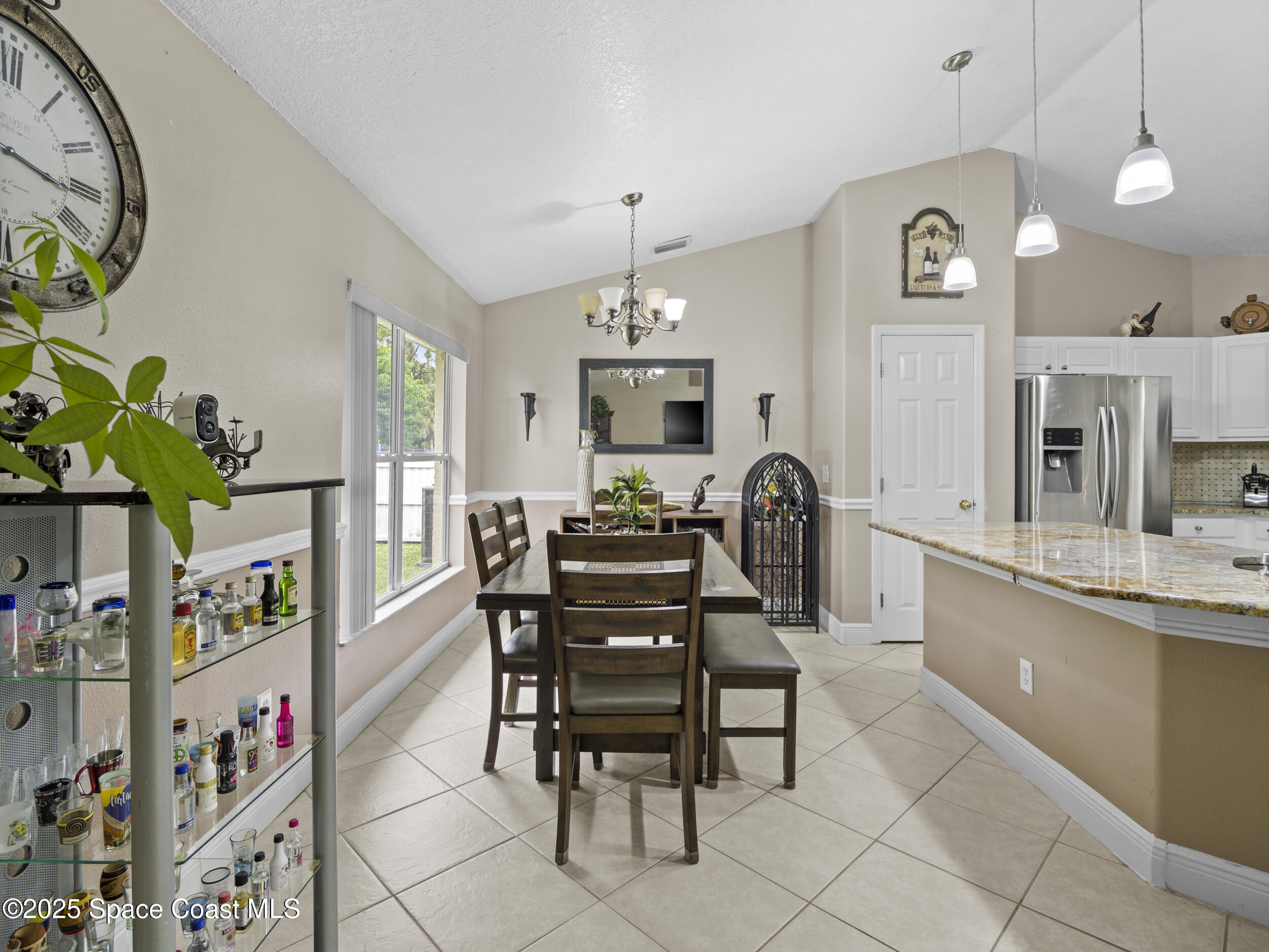 860 Tupelo Road Southwest Palm Bay, FL 32908 - Photo 7 of 26 a view of a dining room with furniture and chandelier