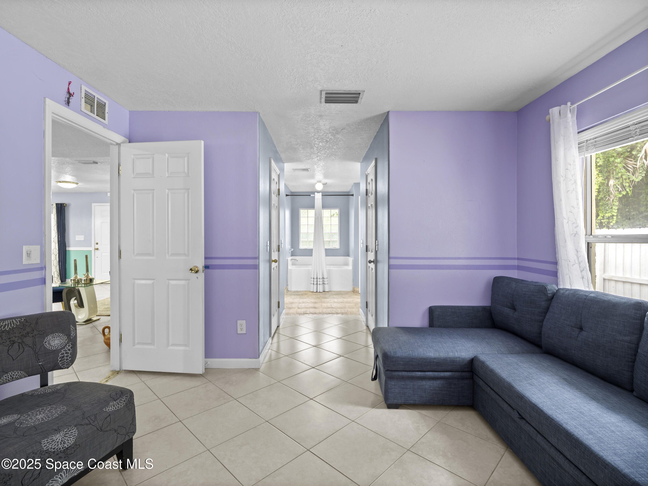 860 Tupelo Road Southwest Palm Bay, FL 32908 - Photo 10 of 26 a living room with furniture and a couch