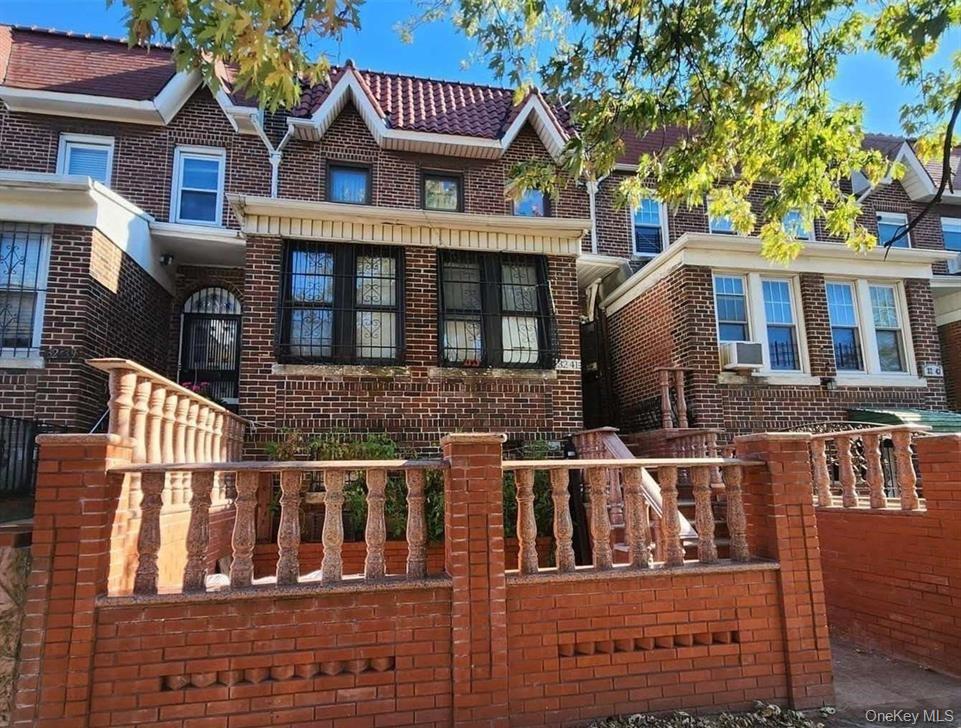 32-41 84th Street Queens, NY 11370 - Photo 1 of 1 a front view of a house with a yard