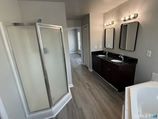 a bathroom with a mirror sink and toilet