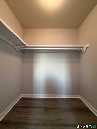 a view of a room with wooden floor and fan