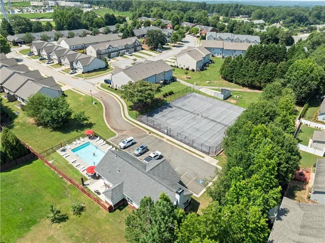 an aerial view of a house with a yard