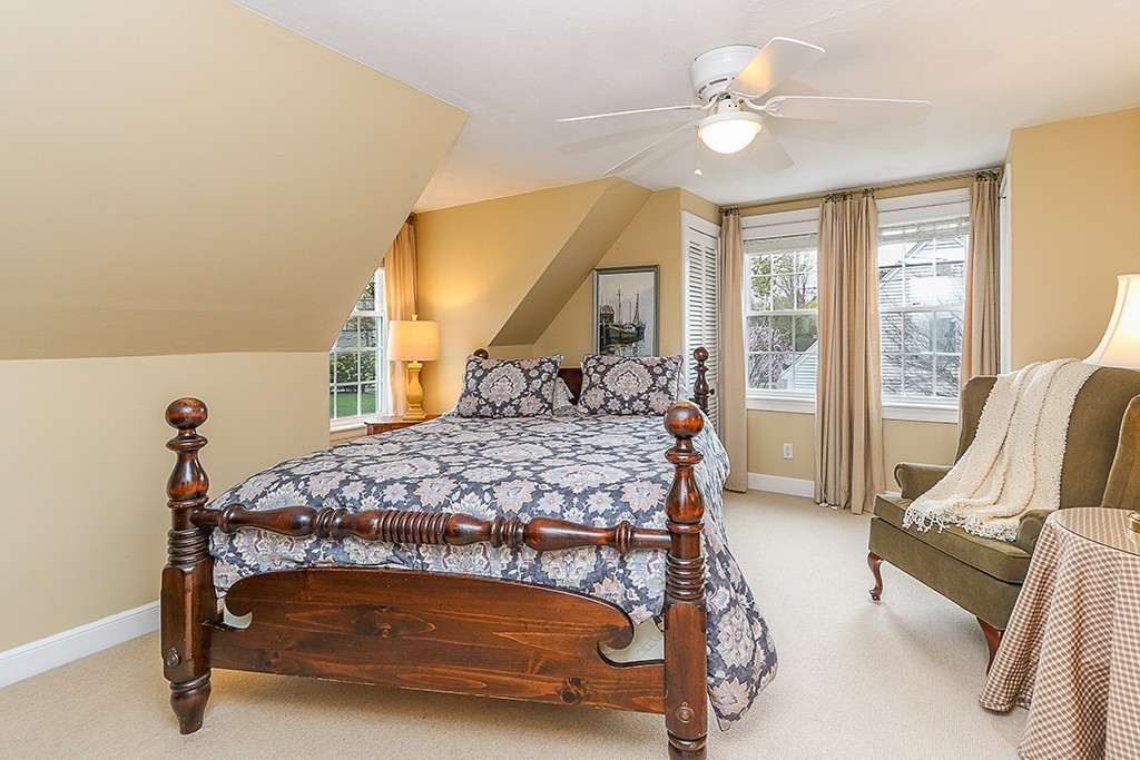 28 Clearwater Road Newton, MA 02462 - Photo 14 of 20 a bedroom with a bed and a chandelier