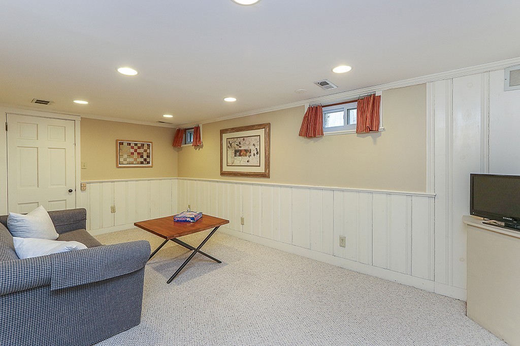 28 Clearwater Road Newton, MA 02462 - Photo 17 of 20 a living room with furniture a rug and a flat screen tv