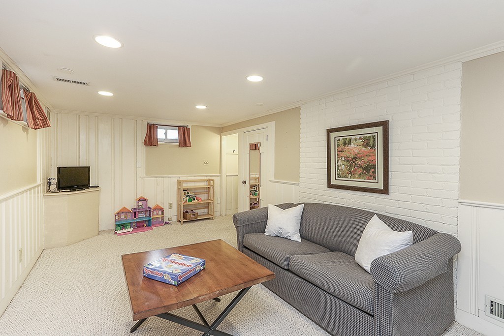28 Clearwater Road Newton, MA 02462 - Photo 18 of 20 a living room with furniture and a flat screen tv