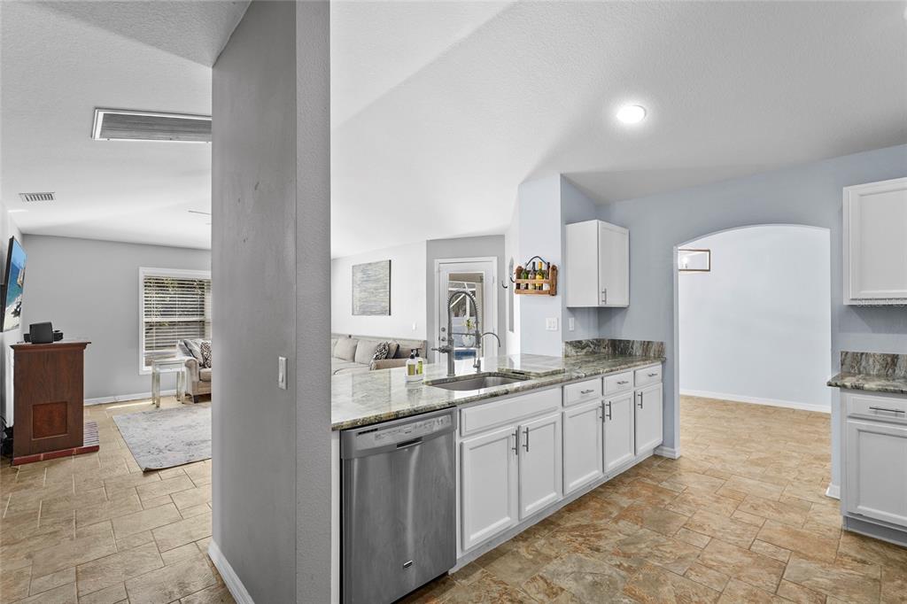 15105 Gulistan Avenue Port Charlotte, FL 33953 - Photo 13 of 39 a kitchen with a sink stove and cabinets