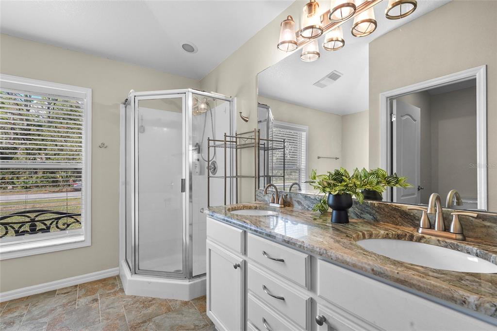 15105 Gulistan Avenue Port Charlotte, FL 33953 - Photo 18 of 39 a bathroom with a granite countertop sink mirror and shower