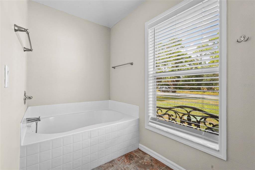 15105 Gulistan Avenue Port Charlotte, FL 33953 - Photo 19 of 39 a white bath tub with a shower