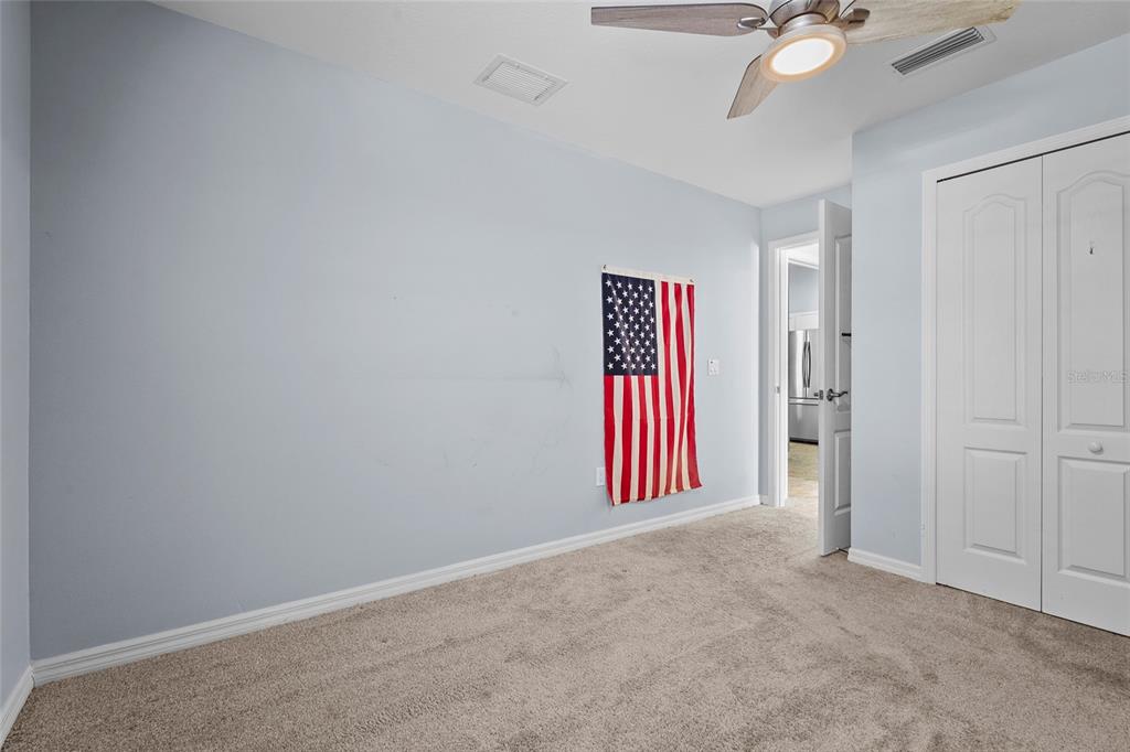 15105 Gulistan Avenue Port Charlotte, FL 33953 - Photo 21 of 39 an empty room with windows and fan