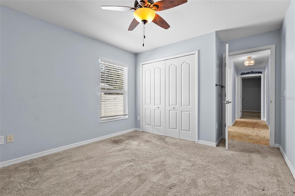 15105 Gulistan Avenue Port Charlotte, FL 33953 - Photo 24 of 39 a view of an empty room with window and chandelier fan