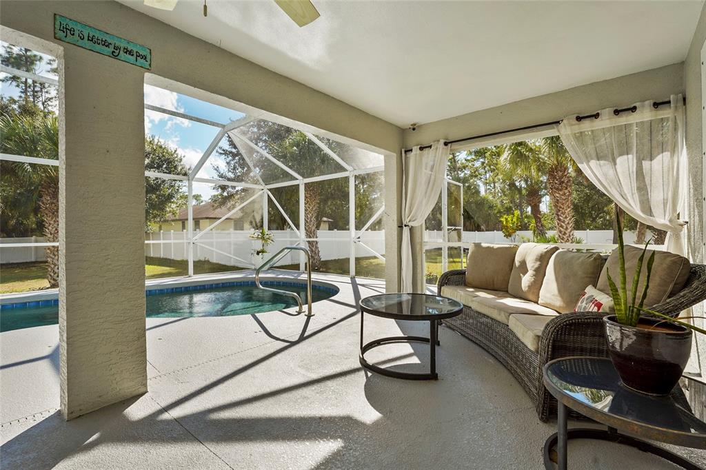 15105 Gulistan Avenue Port Charlotte, FL 33953 - Photo 26 of 39 a living room with furniture a floor to ceiling window and a floor to ceiling window