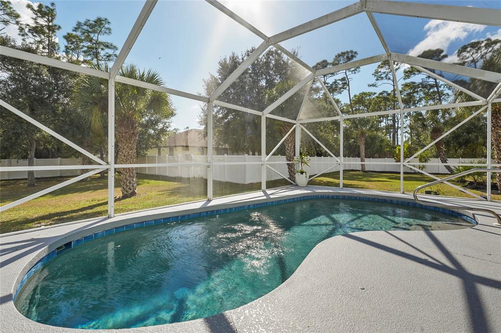 15105 Gulistan Avenue Port Charlotte, FL 33953 - Photo 29 of 39 a view of a swimming pool with a yard and sitting area