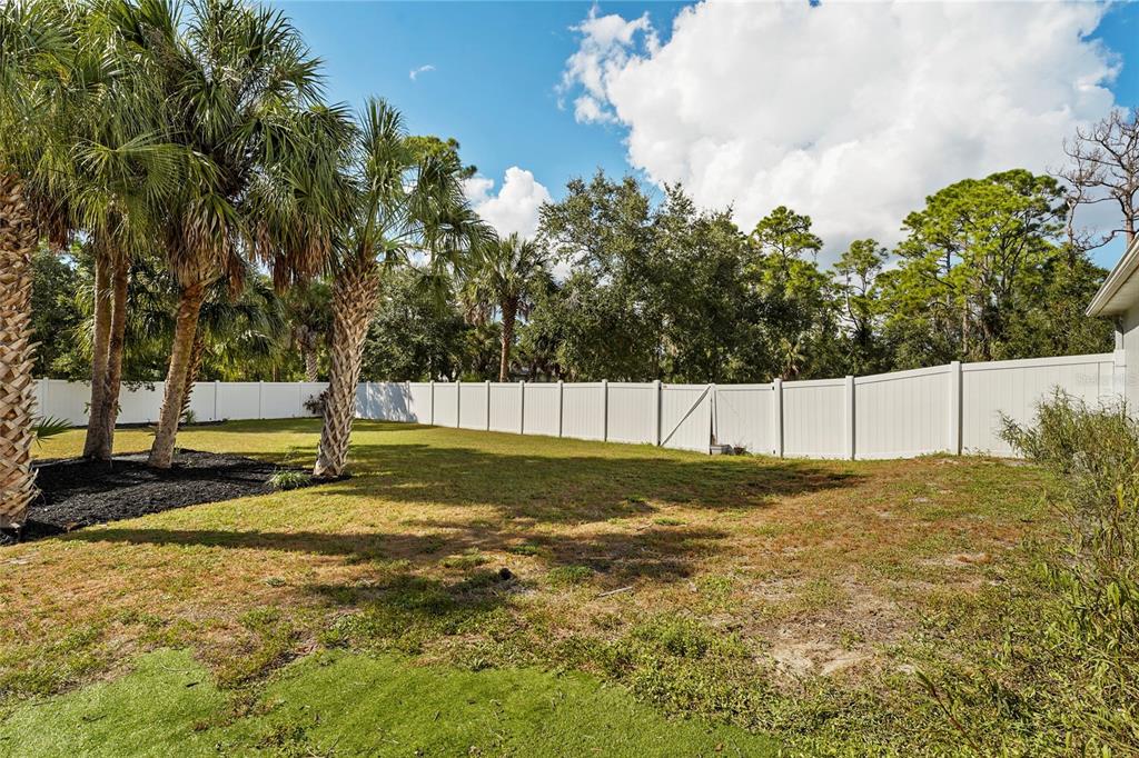 15105 Gulistan Avenue Port Charlotte, FL 33953 - Photo 30 of 39 a view of a yard with trees